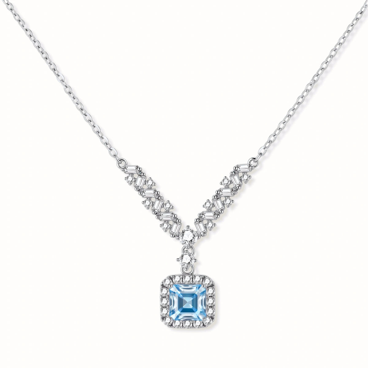 Sterling silver necklace with geometric crystal arrangement forming a V-shape and square blue moissanite centerpiece pendant